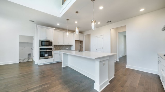 kitchen with oven, tasteful backsplash, dark wood-style floors, white cabinets, and built in microwave