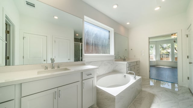 bathroom featuring visible vents, recessed lighting, a bath, marble finish floor, and vanity