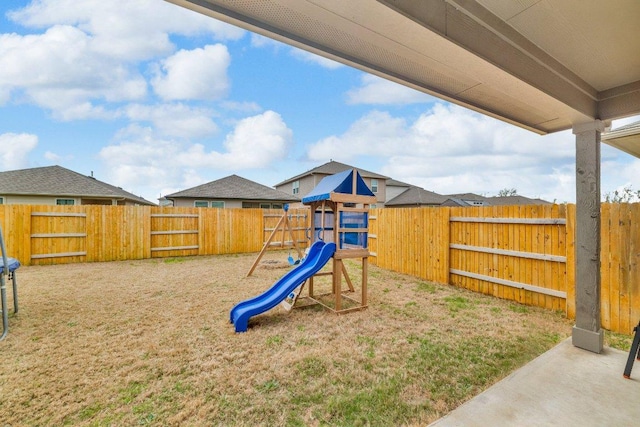 view of jungle gym with a yard and a fenced backyard