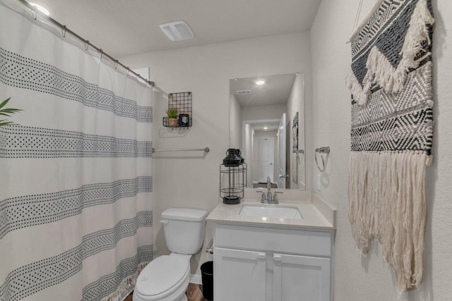 bathroom featuring a shower with curtain, toilet, and vanity