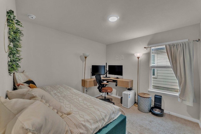 bedroom featuring baseboards and carpet flooring