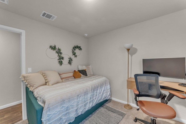 bedroom featuring visible vents and baseboards