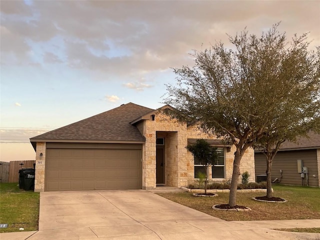 single story home with fence, concrete driveway, a front yard, roof with shingles, and a garage