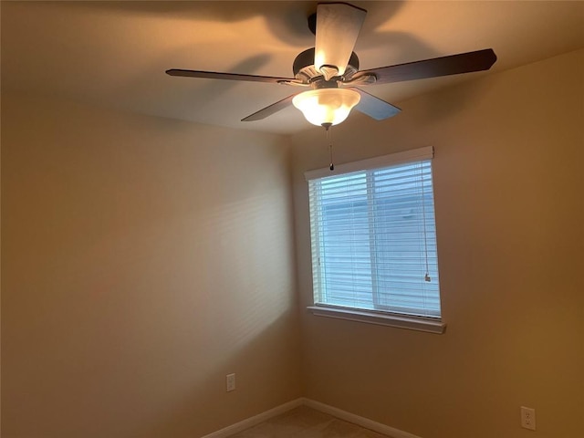 empty room featuring baseboards and ceiling fan
