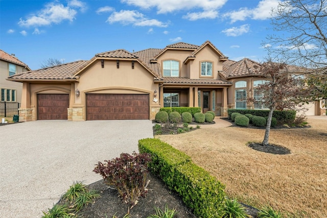 mediterranean / spanish-style home featuring gravel driveway, an attached garage, stucco siding, stone siding, and a tile roof