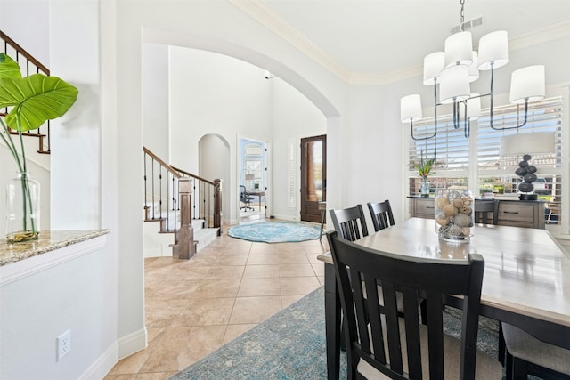 dining space featuring visible vents, ornamental molding, stairway, arched walkways, and light tile patterned floors