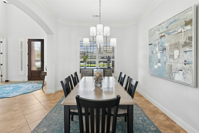 dining area featuring a notable chandelier, visible vents, tile patterned floors, and ornamental molding