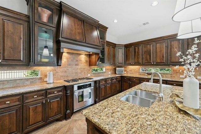 kitchen featuring a sink, visible vents, appliances with stainless steel finishes, and decorative backsplash