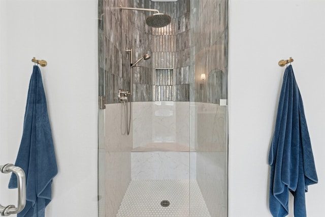 full bath with a tile shower