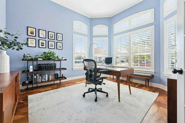 office space featuring a healthy amount of sunlight, crown molding, baseboards, and wood finished floors