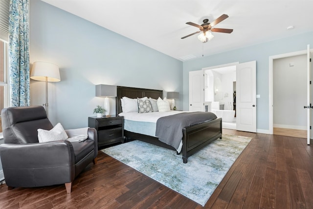 bedroom featuring baseboards, ensuite bath, ceiling fan, and hardwood / wood-style flooring