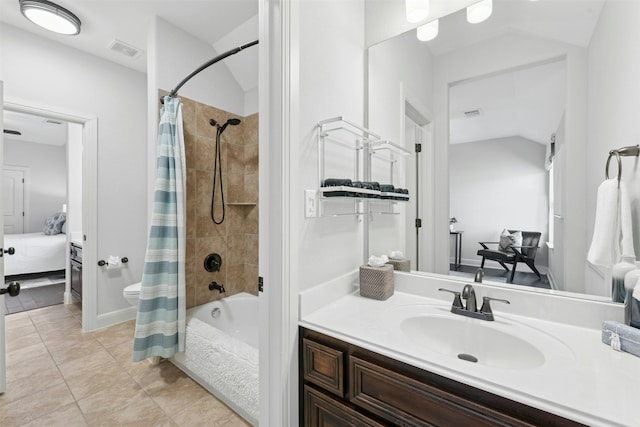 ensuite bathroom with vanity, visible vents, vaulted ceiling, tile patterned floors, and connected bathroom