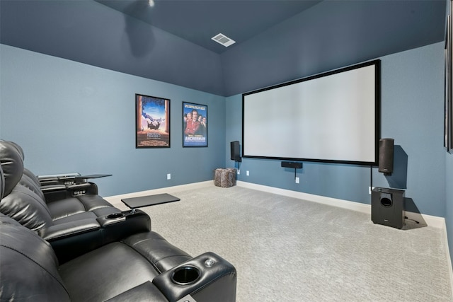 carpeted home theater featuring visible vents and baseboards