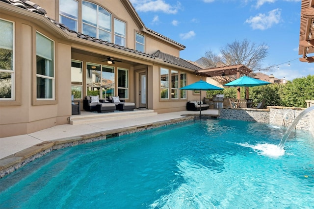 outdoor pool with a ceiling fan, an outdoor living space, and a patio area