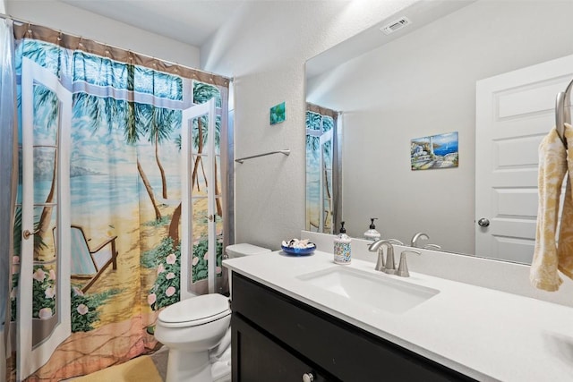 bathroom featuring visible vents, toilet, a shower with curtain, a textured wall, and vanity