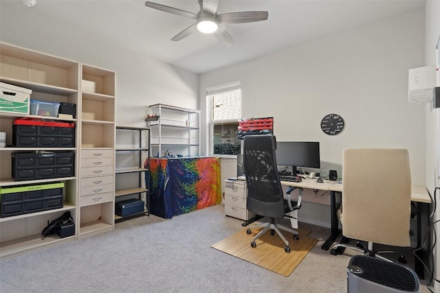 carpeted home office with a ceiling fan