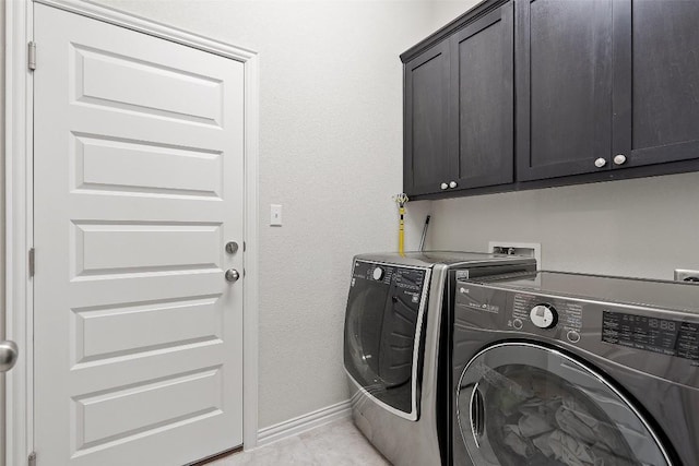 laundry room with cabinet space, independent washer and dryer, and baseboards