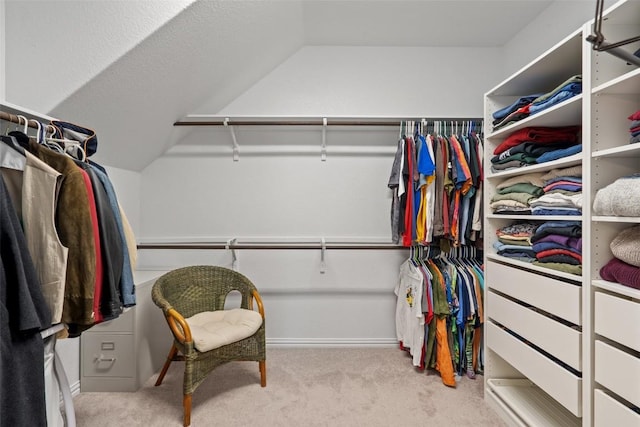 walk in closet featuring carpet and vaulted ceiling