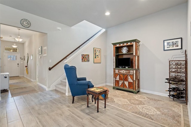 sitting room with recessed lighting, baseboards, stairs, and wood finish floors