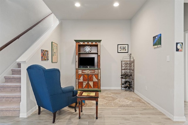 living area featuring recessed lighting, stairway, wood finish floors, and baseboards