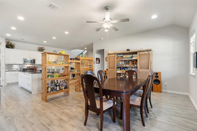 dining room with visible vents, baseboards, light wood-type flooring, vaulted ceiling, and recessed lighting