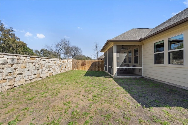 view of yard featuring a fenced backyard and a sunroom