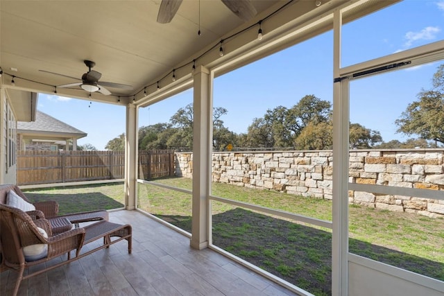 sunroom / solarium featuring ceiling fan