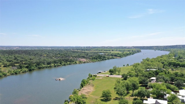 drone / aerial view featuring a water view and a view of trees