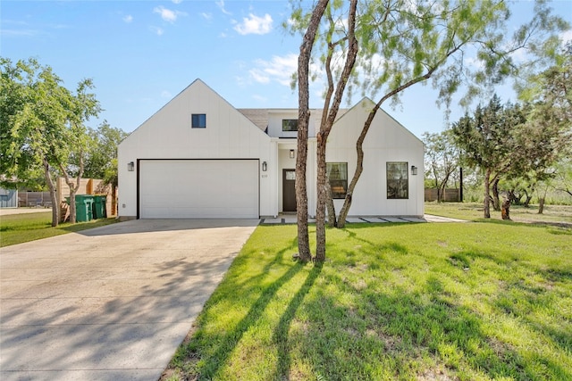 modern farmhouse style home with board and batten siding, a front lawn, concrete driveway, and a garage