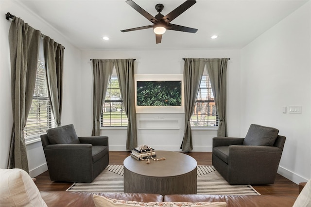 living area featuring a ceiling fan, recessed lighting, wood finished floors, and baseboards