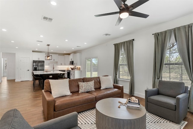 living room featuring visible vents, recessed lighting, light wood-type flooring, and ceiling fan