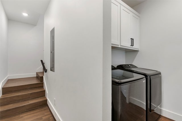 laundry room featuring baseboards, washer and clothes dryer, recessed lighting, wood finished floors, and cabinet space