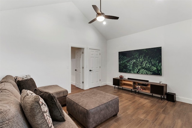 living area with a ceiling fan, wood finished floors, baseboards, and high vaulted ceiling