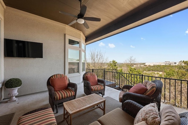 view of patio featuring a balcony, an outdoor hangout area, and a ceiling fan