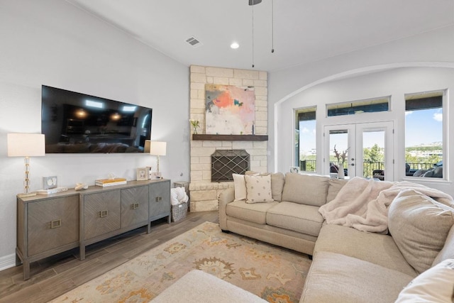 living area with wood finished floors, recessed lighting, french doors, and visible vents