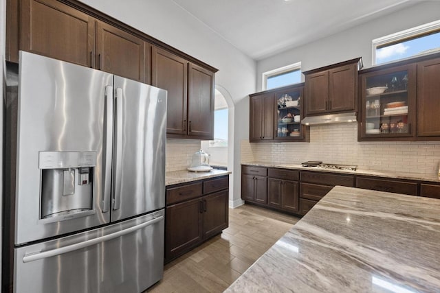 kitchen featuring under cabinet range hood, plenty of natural light, appliances with stainless steel finishes, and dark brown cabinets