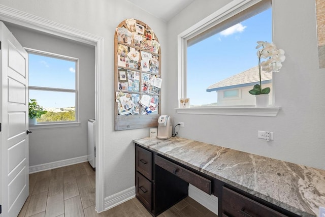 bathroom with washer / clothes dryer, baseboards, and wood tiled floor