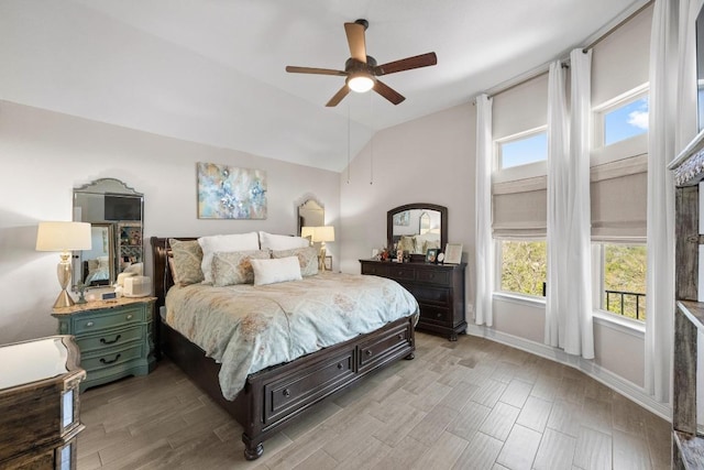 bedroom with baseboards, lofted ceiling, light wood-style floors, and a ceiling fan