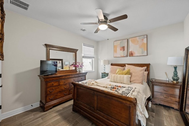 bedroom featuring visible vents, ceiling fan, baseboards, and wood finish floors