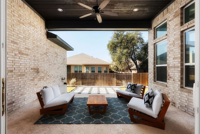 view of patio featuring an outdoor living space, a ceiling fan, and fence