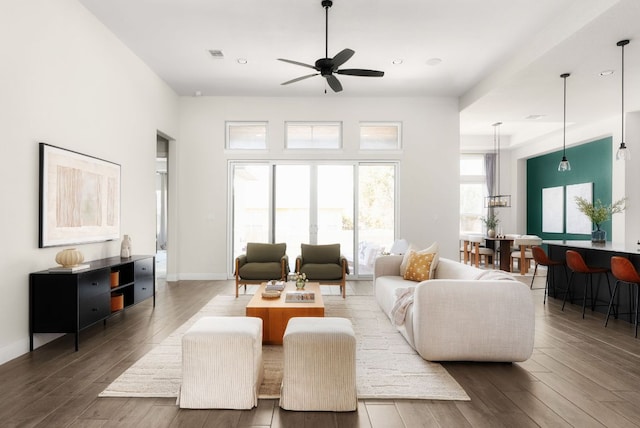 living area featuring visible vents, a ceiling fan, wood finished floors, recessed lighting, and baseboards