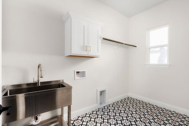 laundry area featuring baseboards, washer hookup, tile patterned floors, cabinet space, and a sink