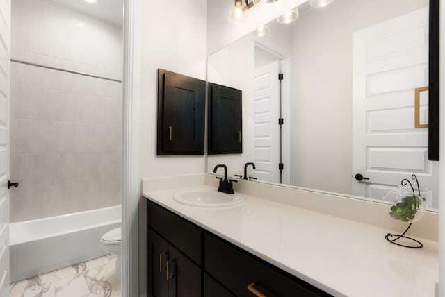 full bathroom featuring toilet, marble finish floor, vanity, and shower / tub combination