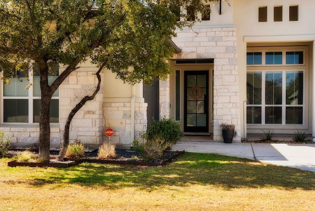 entrance to property featuring stone siding