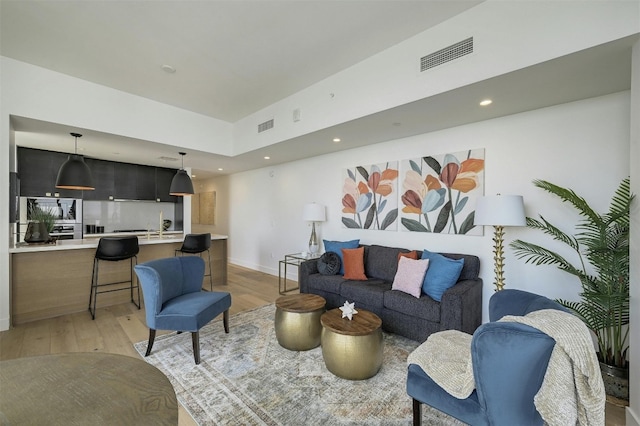 70 Rainey St Unit 1807, Austin, TX 78701 - living room with light wood-style floors and recessed lighting