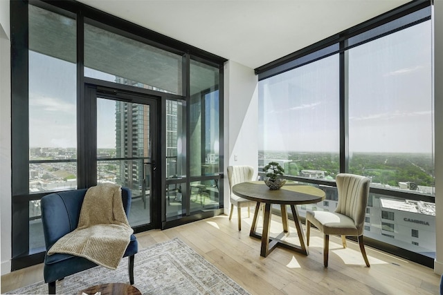 70 Rainey St Unit 1807, Austin, TX 78701 - sunroom / solarium with expansive windows, wood finished floors, and a city view
