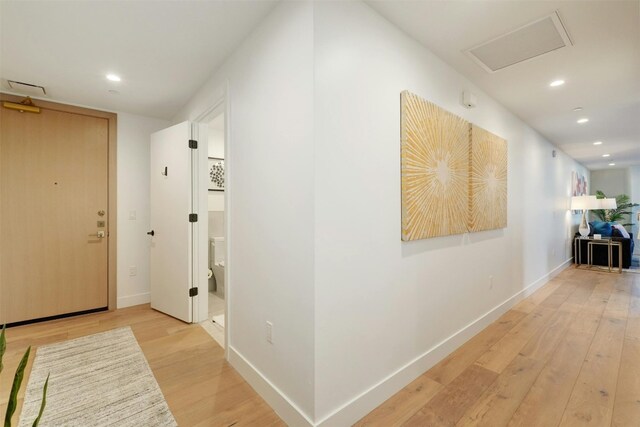 70 Rainey St Unit 1807, Austin, TX 78701 - hallway with light wood-type flooring, recessed lighting, and attic access