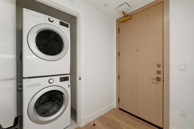 70 Rainey St Unit 1807, Austin, TX 78701 - laundry room featuring stacked washer and clothes dryer and light wood finished floors