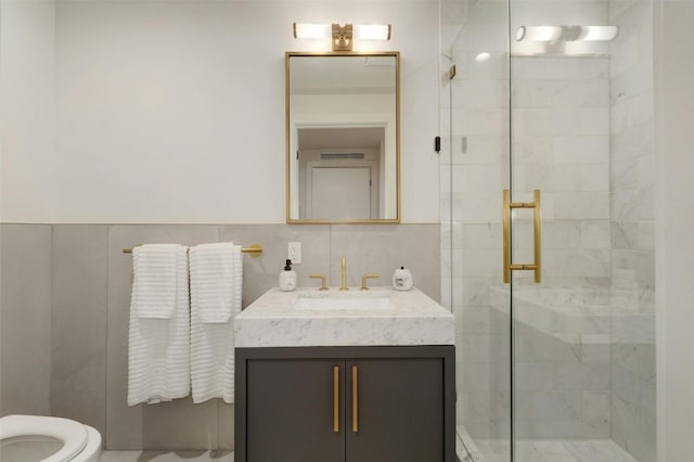 70 Rainey St Unit 1807, Austin, TX 78701 - bathroom featuring a stall shower, vanity, and tile walls