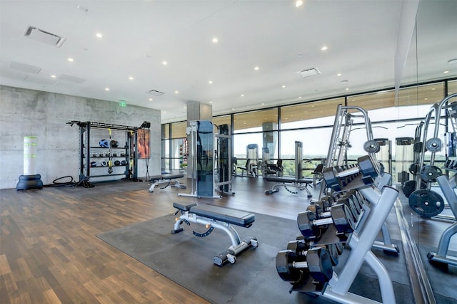 70 Rainey St Unit 1807, Austin, TX 78701 - gym with a wall of windows, wood finished floors, and recessed lighting